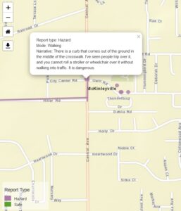 A map shows streets in central McKinleyville, with purple dots and lines showing reports of hazardous locations. A text box shows a report about a dangerous curb in a crosswalk that blocks access and is a tripping hazard.