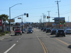 Lines of cars fill all 4 lanes of Eureka's Broadway at the intersection with 6th Street