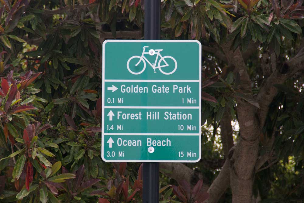 A bike wayfinding sign from San Francisco is attached to a metal post